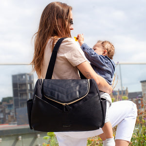 Babymel award winning nappy bags |  Pippa vegan Leather black | shoulder baby bag on mum